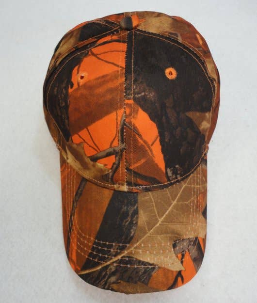 A baseball cap featuring an orange, brown, and black leaf-and-branch camouflage pattern, photographed against a plain light background.