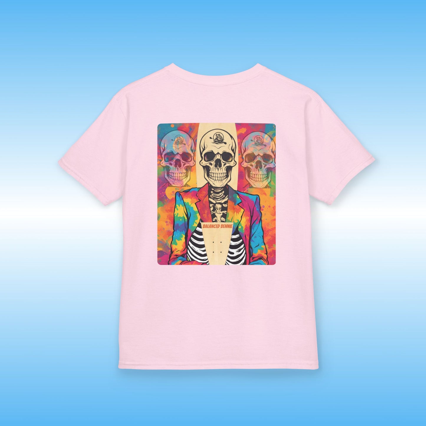 Balanced Bennie light Pink t-shirt with a colorful skull design on a blue background