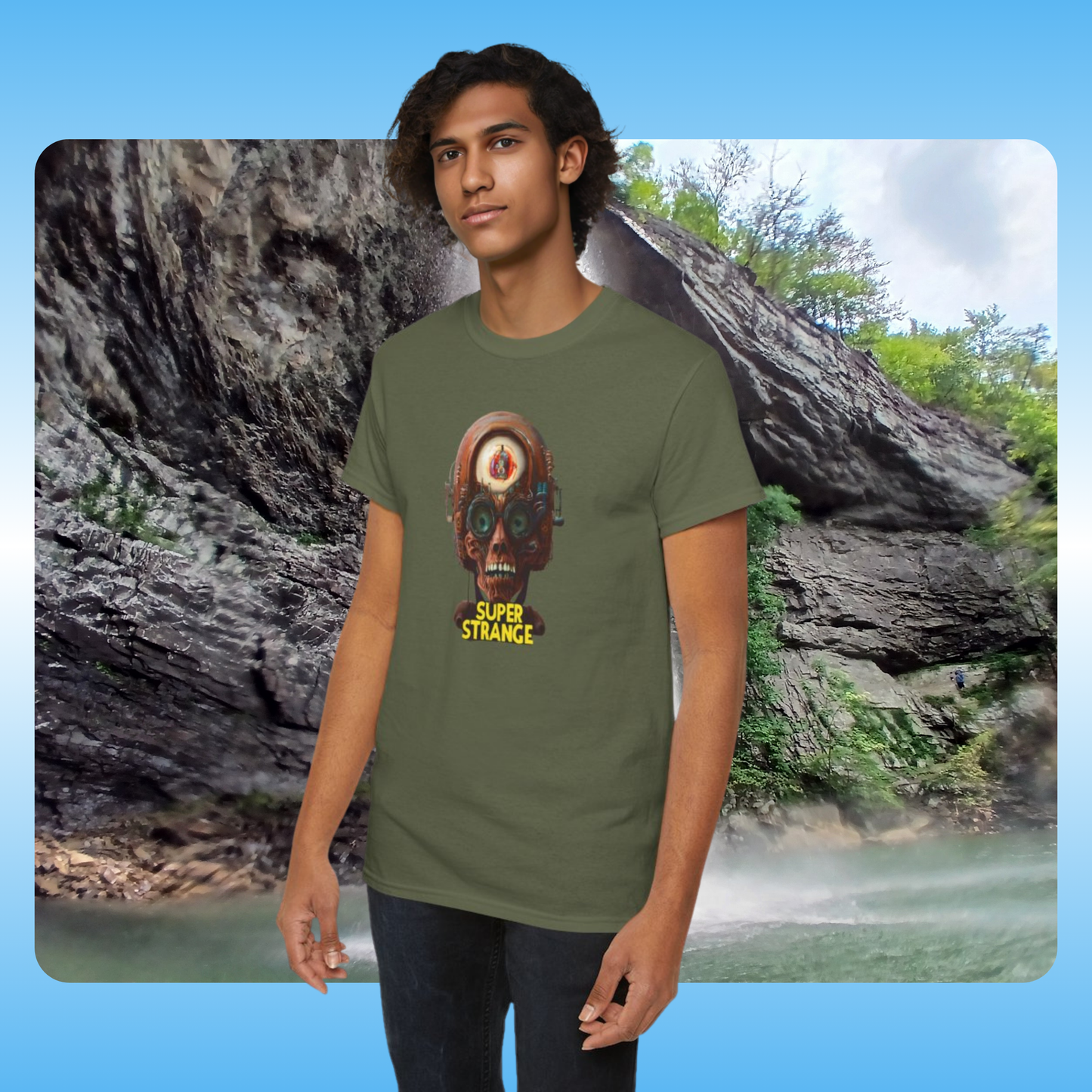 Person wearing a green t-shirt with a graphic design in front of a natural landscape.