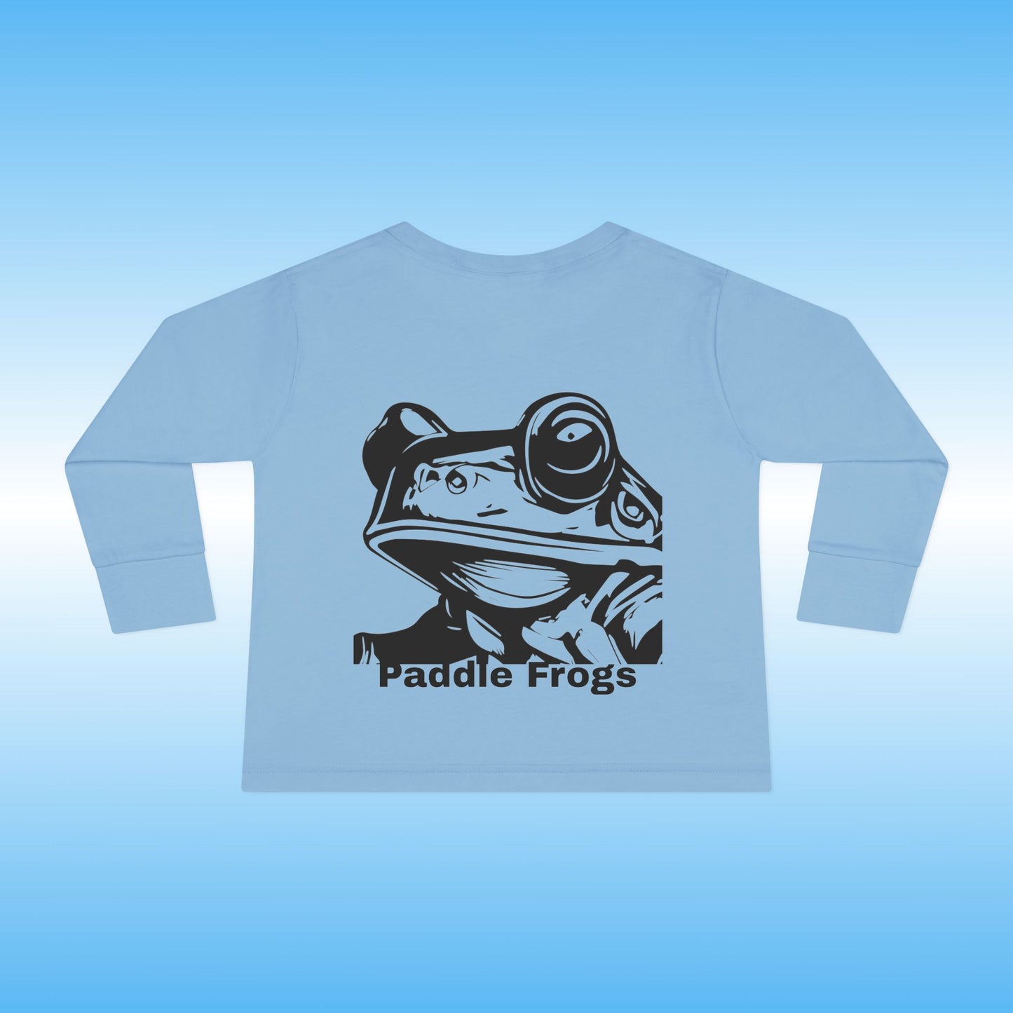 Light blue long-sleeve shirt with a black frog graphic and 'Paddle Frogs' text on a light blue background