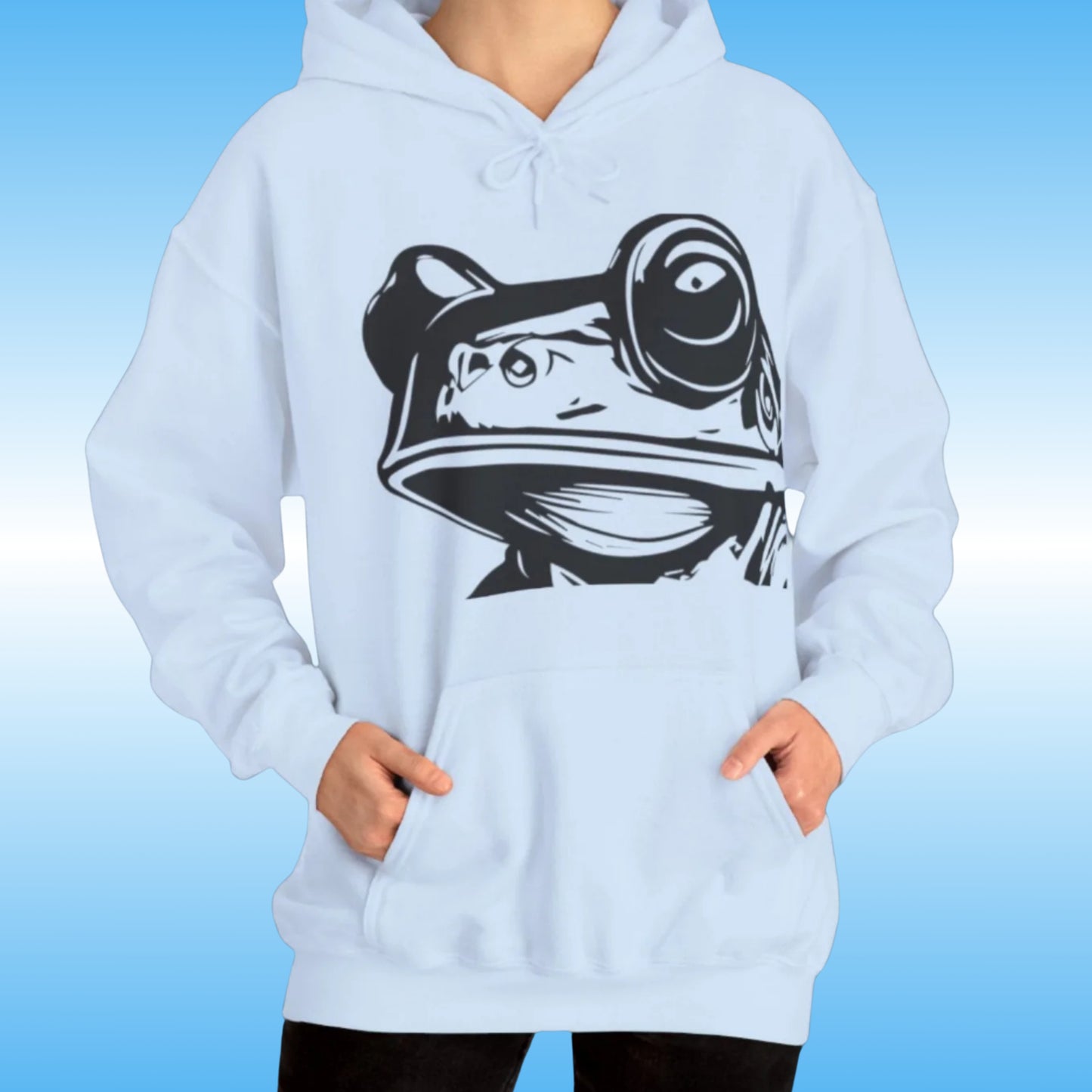 Bill – The Hoodie with Purpose Blue on a human woman frontside with bill the creature character from Paddle Frogs logo
