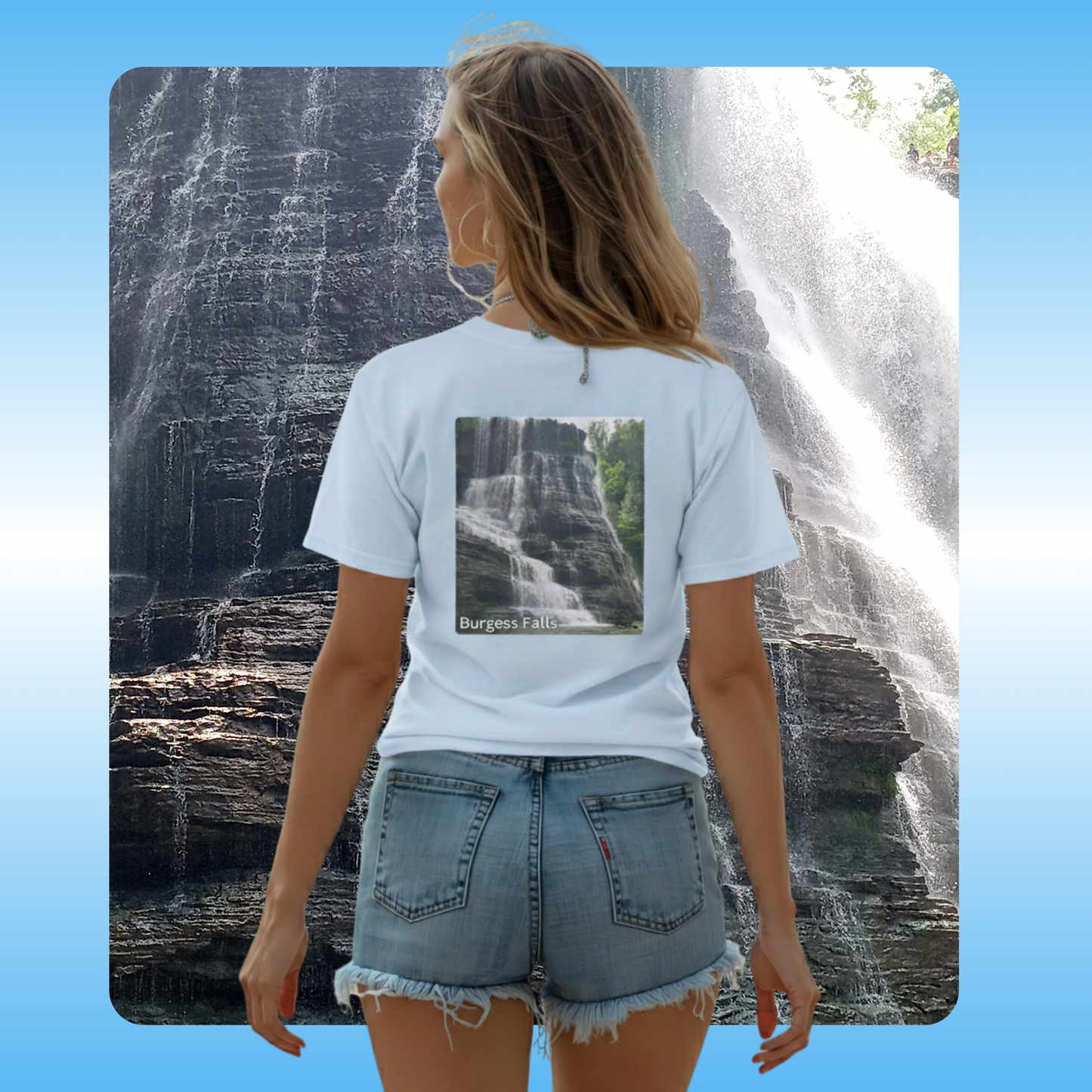 Burgess Falls | Paddle Frogs™ T-shirts worn in light blue by Megan | Person wearing a light blue t-shirt with a waterfall design, standing in front of a real waterfall.