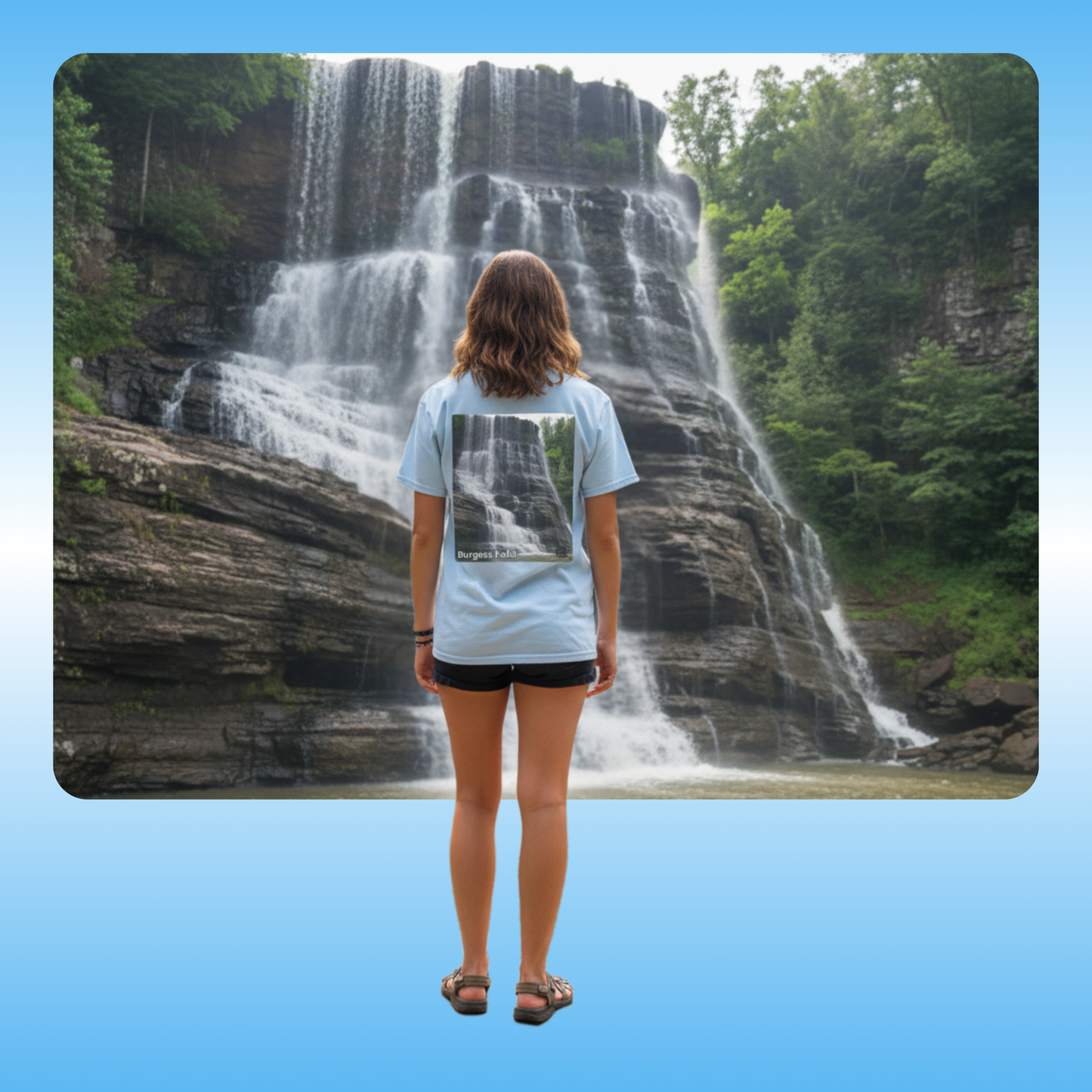 Burgess Falls, T-Shirt | Paddle Frogs Outdoor Gear | Tee | Person standing in front of a waterfall wearing a light blue t-shirt with a graphic design.