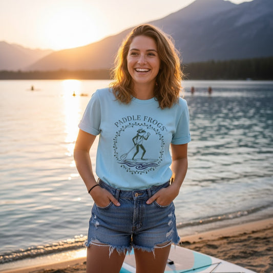 Country Paddler - | Paddle Frogs: T-shirt | a light blue paddleboarding tee model at the mountain lake beach