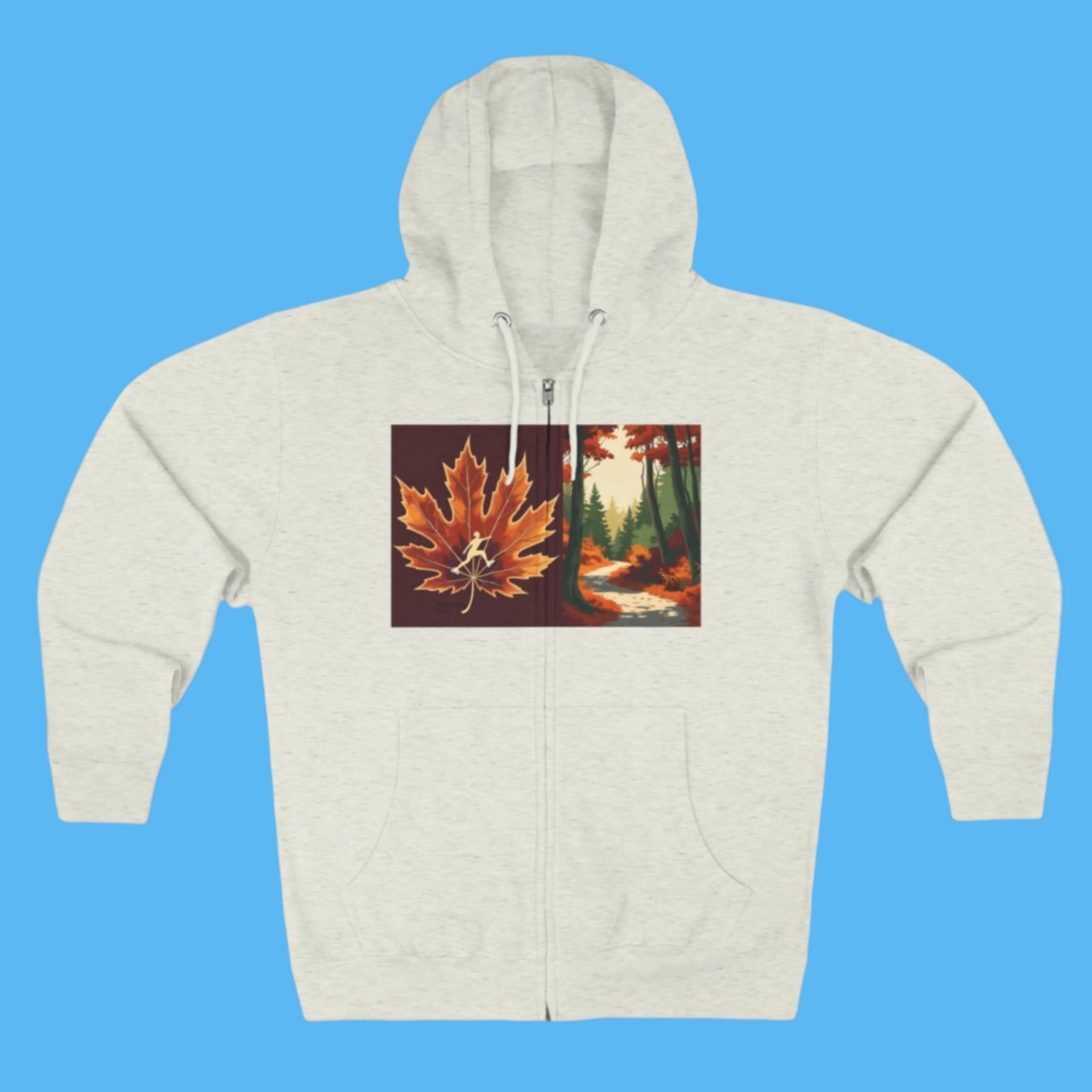 Gray hoodie with a maple leaf and forest design Autumn Trail hoodie with Zipper and Pockets. Cozy hood and a maple leaf with an ice skater and fall season forest design on a path to Autumn's Trail in the Paddle Frogs crew story.