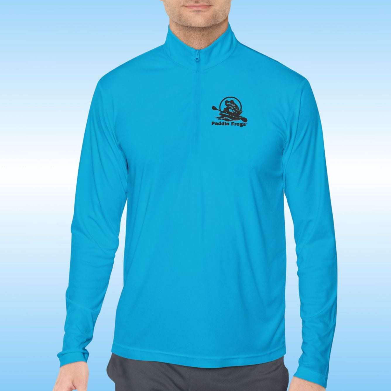 Man wearing a blue long-sleeve shirt with a Paddle Frogs logo on a blue background