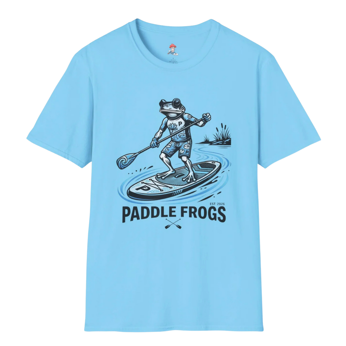 A light sky blue short-sleeve crewneck 100% cotton t-shirt featuring a graphic of a frog paddleboarding with the text 'PADDLE FROGS' printed below it.