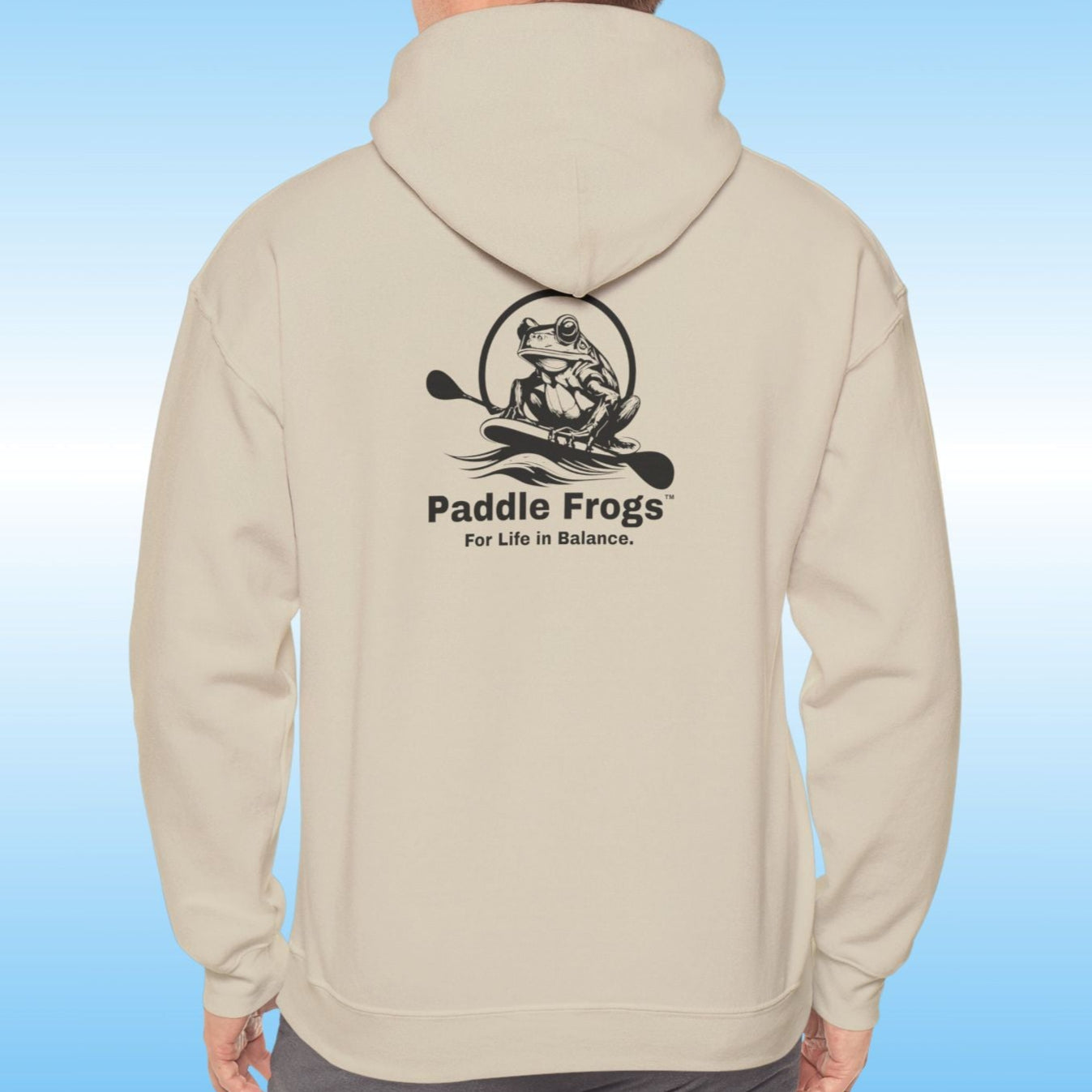Paddle Frogs original Hoodie in multiple colors Paddle boarding frog Person man wearing a sand tan hoodie with a logo on a blue background