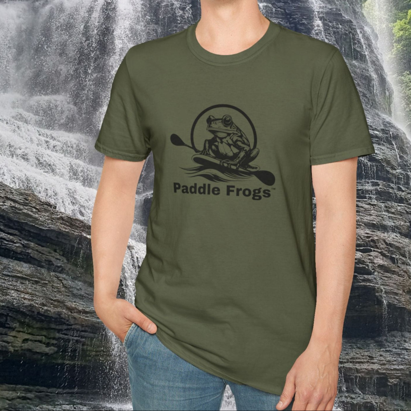 Person wearing a green t-shirt with 'Paddle Frogs' design in front of a waterfall. Burgess Falls in Sparta Tennessee