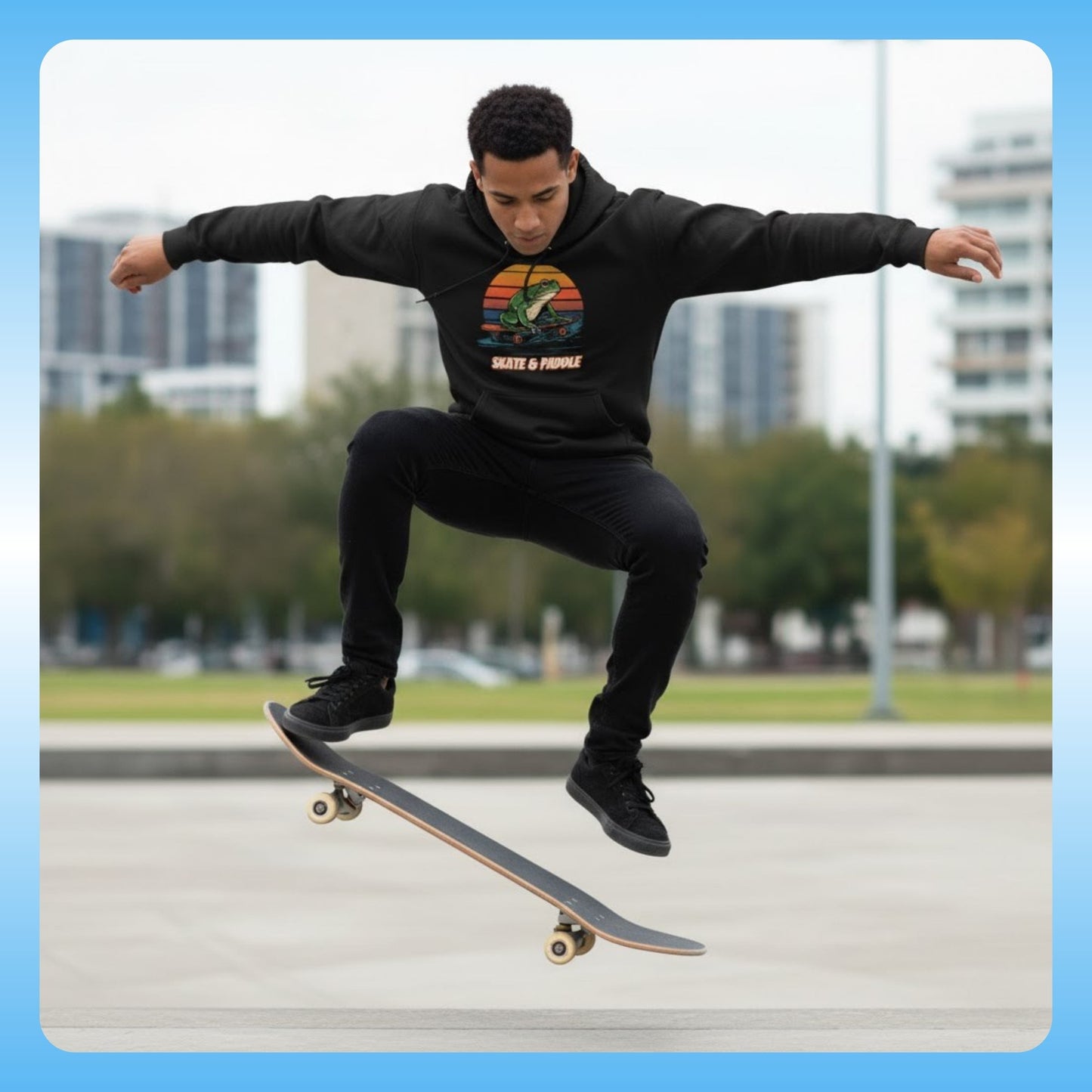Skateboard Ollie | Paddle Frogs™ Skate & Paddle Hoodie | Poetic Balance Black Retro - Skating at the park with city buildings in the background