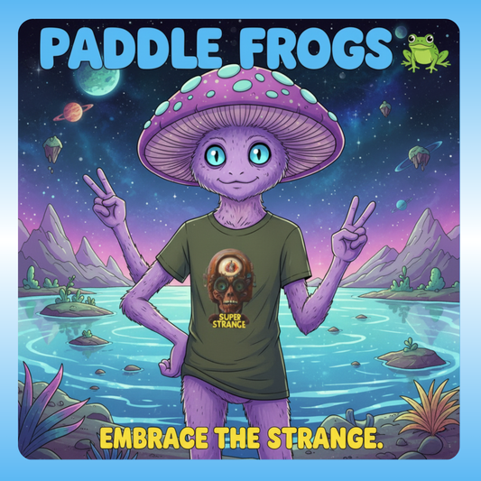 Super Strange Tee by Paddle Frogs Outdoor Gear Embrace the Strange. Illustration of a frog-like character with a mushroom helmet in a fantasy landscape, with 'Paddle Frogs' branding.