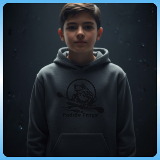 Super Strange | Youth Hooded Sweatshirt | Paddle Frogs™ Child wearing a hoodie with 'Paddle Frogs' logo against a dark background