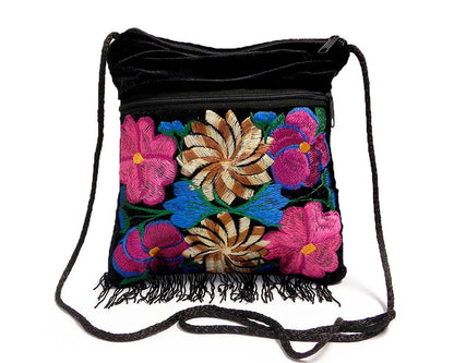 Black drawstring bag with colorful floral embroidery on a white background