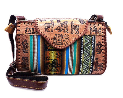 Brown leather crossbody bag with tribal patterns and colorful stripes on a white background