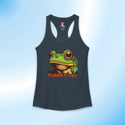 A dark solid indigo racerback tank top featuring a colorful graphic of a green frog with large eyes and the text 'Paddle Frogs' in orange below it, displayed against a light blue gradient background.