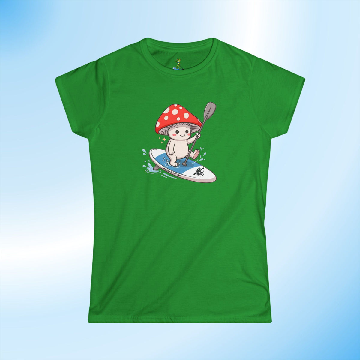 A green ladies short-sleeve crewneck t-shirt featuring a cartoon graphic of a white mushroom character Shiro on a blue & white paddleboard.