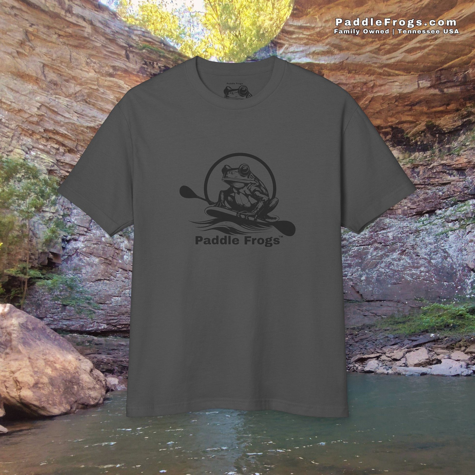 Gray t-shirt with 'Paddle Frogs' logo against a natural rock and water background