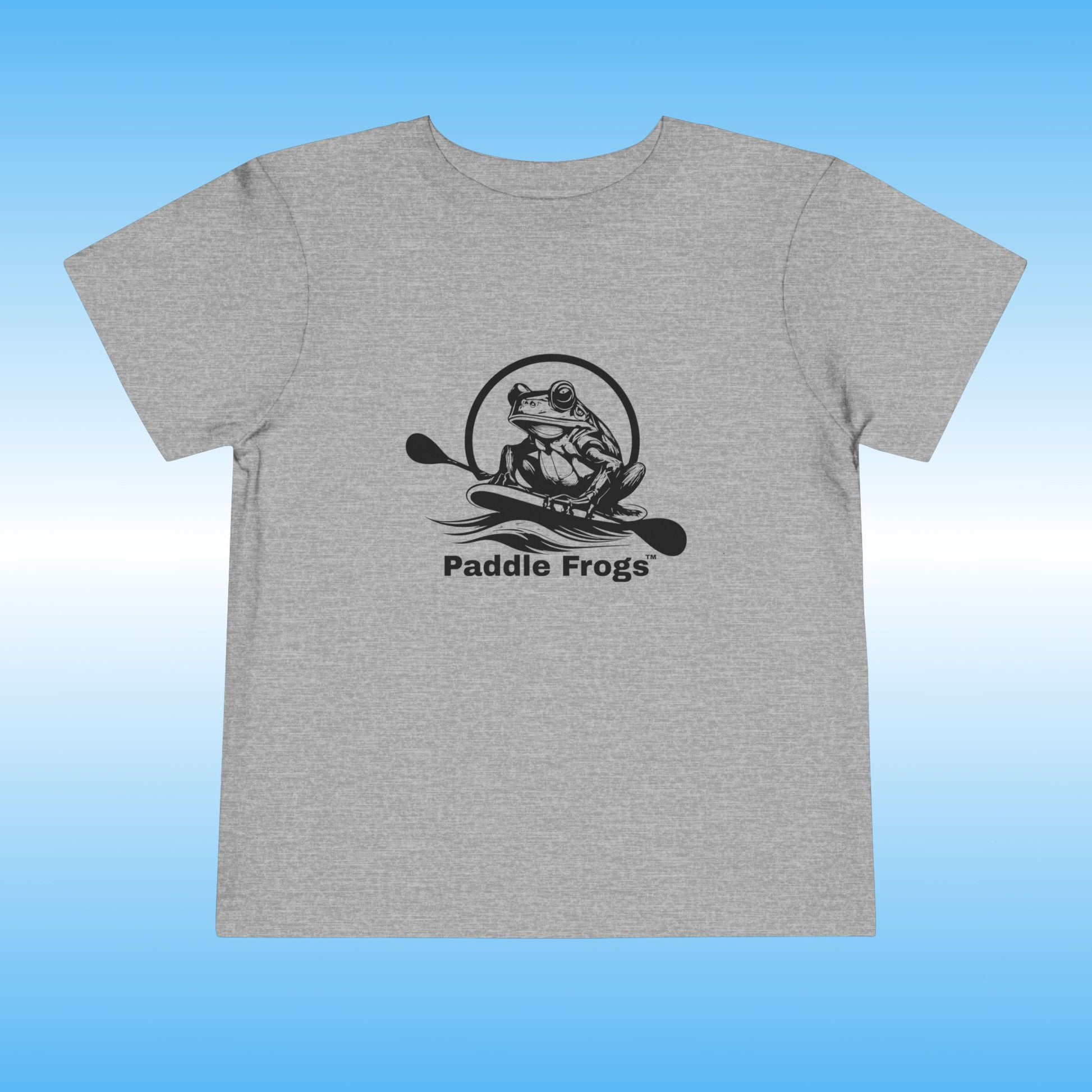 Gray t-shirt with black frog graphic and 'Paddle Frogs' text on a blue gradient background