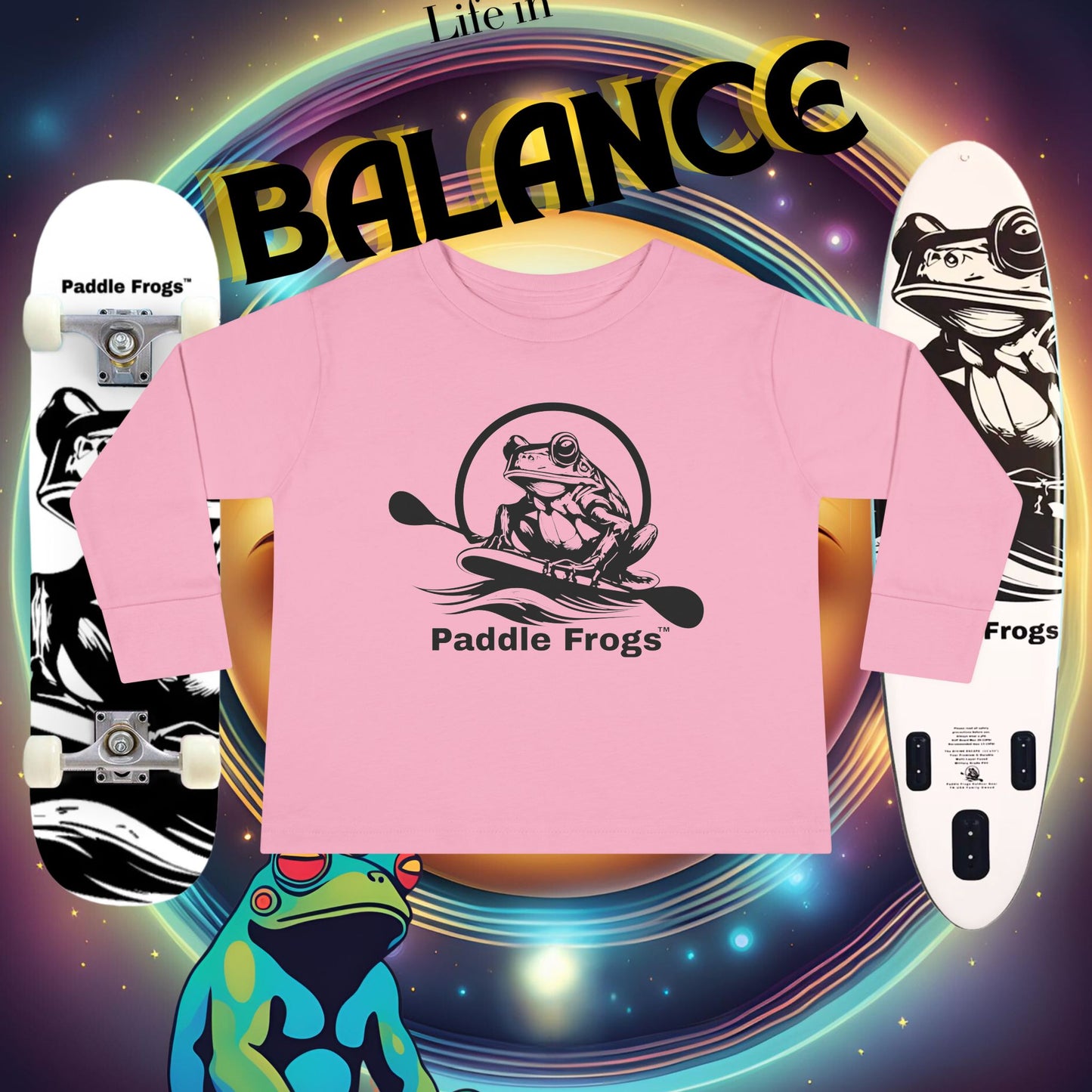 Pink t-shirt with 'Paddle Frogs' logo on a colorful background with a paddle board and skateboards and frogs.