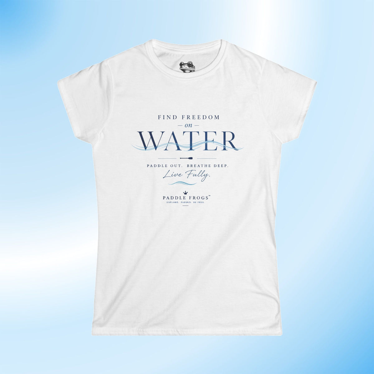A white short-sleeve crewneck t-shirt with a blue graphic print on the front reading 'FIND FREEDOM ON WATER' and 'PADDLE FROGS', displayed against a light blue gradient background.