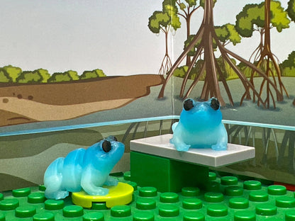 Frog fidget friend, light blue. with an included play scene background.