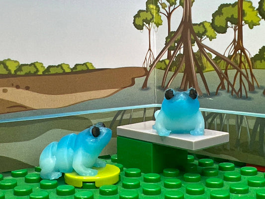 Frog fidget friend, light blue. with an included play scene background.