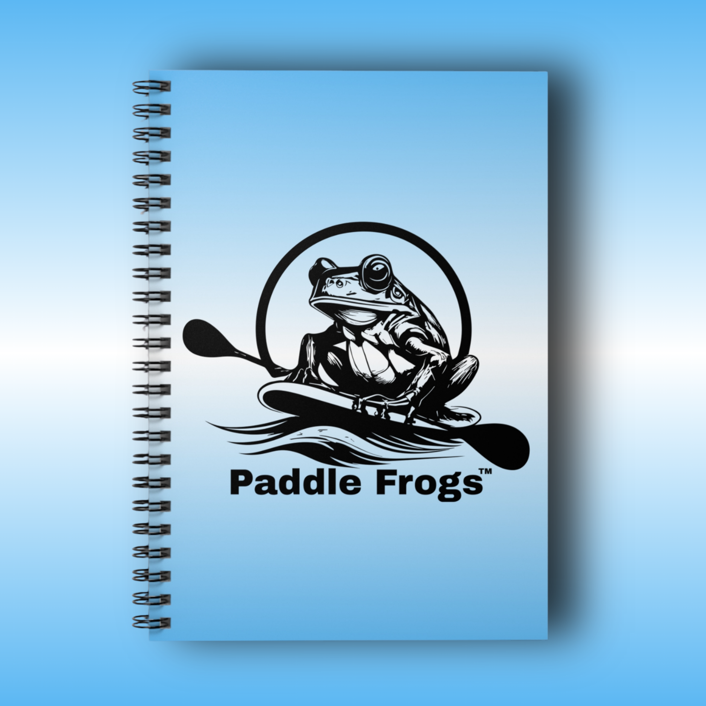 journal Notebook with a frog design and 'Paddle Frogs' text on a blue background