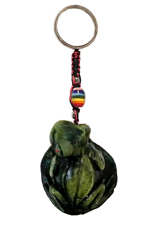 Green tree frog shaped keychain with a colorful bead on a white background