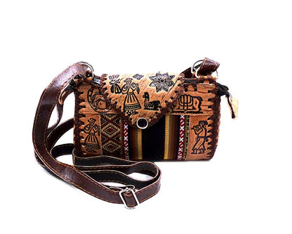 Brown leather purse crossbody bag with intricate patterns on a white background