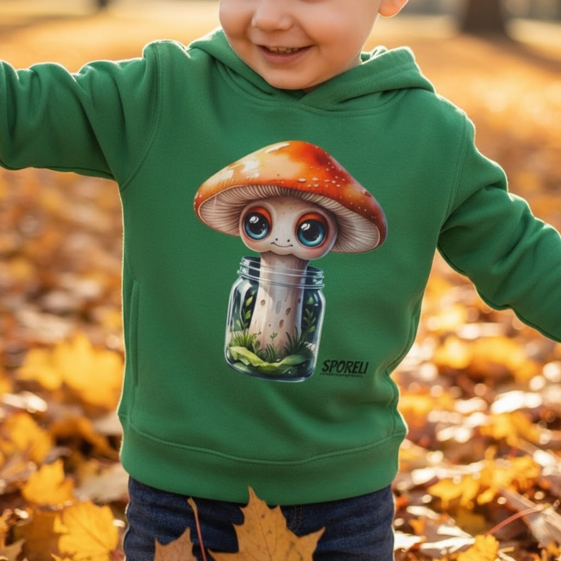 3 year old boy playing in the autumn leaves wearing Sporeli Toddler Hoodie | Mushroom in a Jar | Paddle Frogs™ Kelly Green
