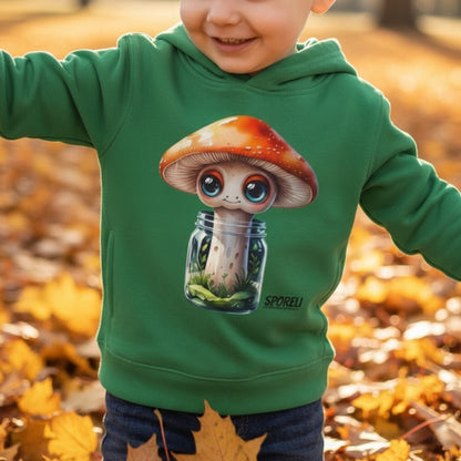3 year old boy playing in the autumn leaves wearing Sporeli Toddler Hoodie | Mushroom in a Jar | Paddle Frogs™ Kelly Green