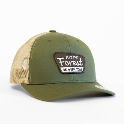 Green and beige cap with a May the Forest be with you patch on a white background