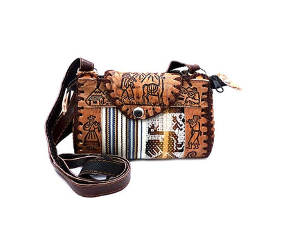 Brown leather crossbody hand bag with tribal patterns on a white background