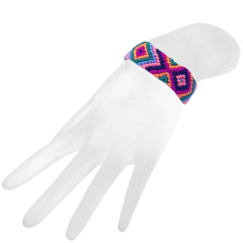 Colorful woven bracelet on a white mannequin hand against a white background