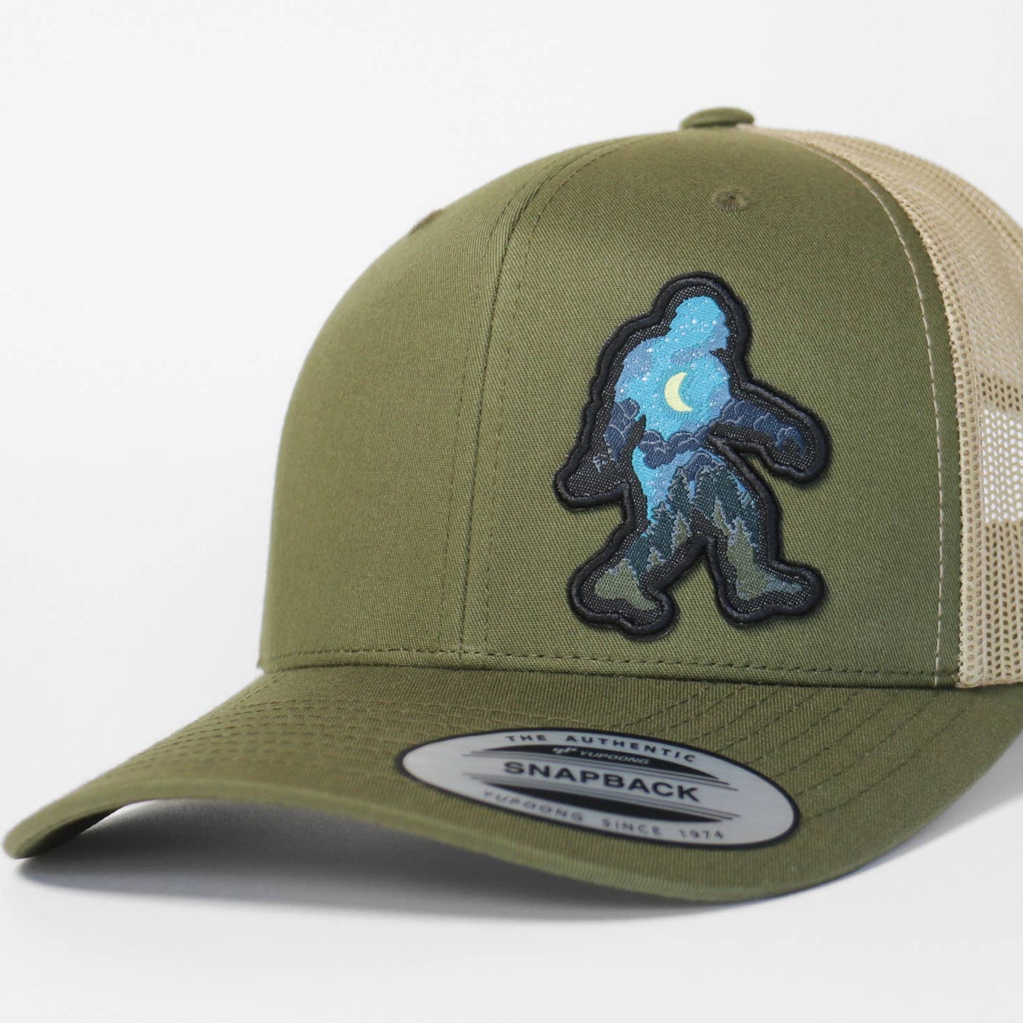Green and beige cap with a Sasquatch logo on a white background