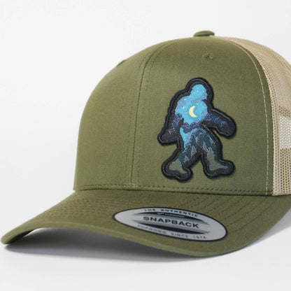 Green and beige cap with a Sasquatch logo on a white background