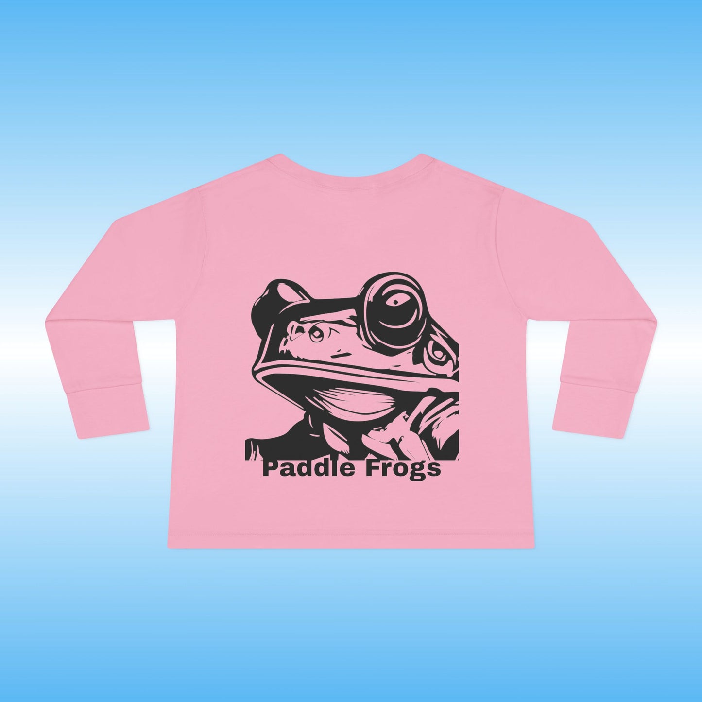 Pink long-sleeve shirt with 'Paddle Frogs' graphic on a blue background