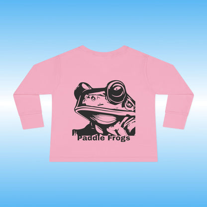 Pink long-sleeve shirt with 'Paddle Frogs' graphic on a blue background