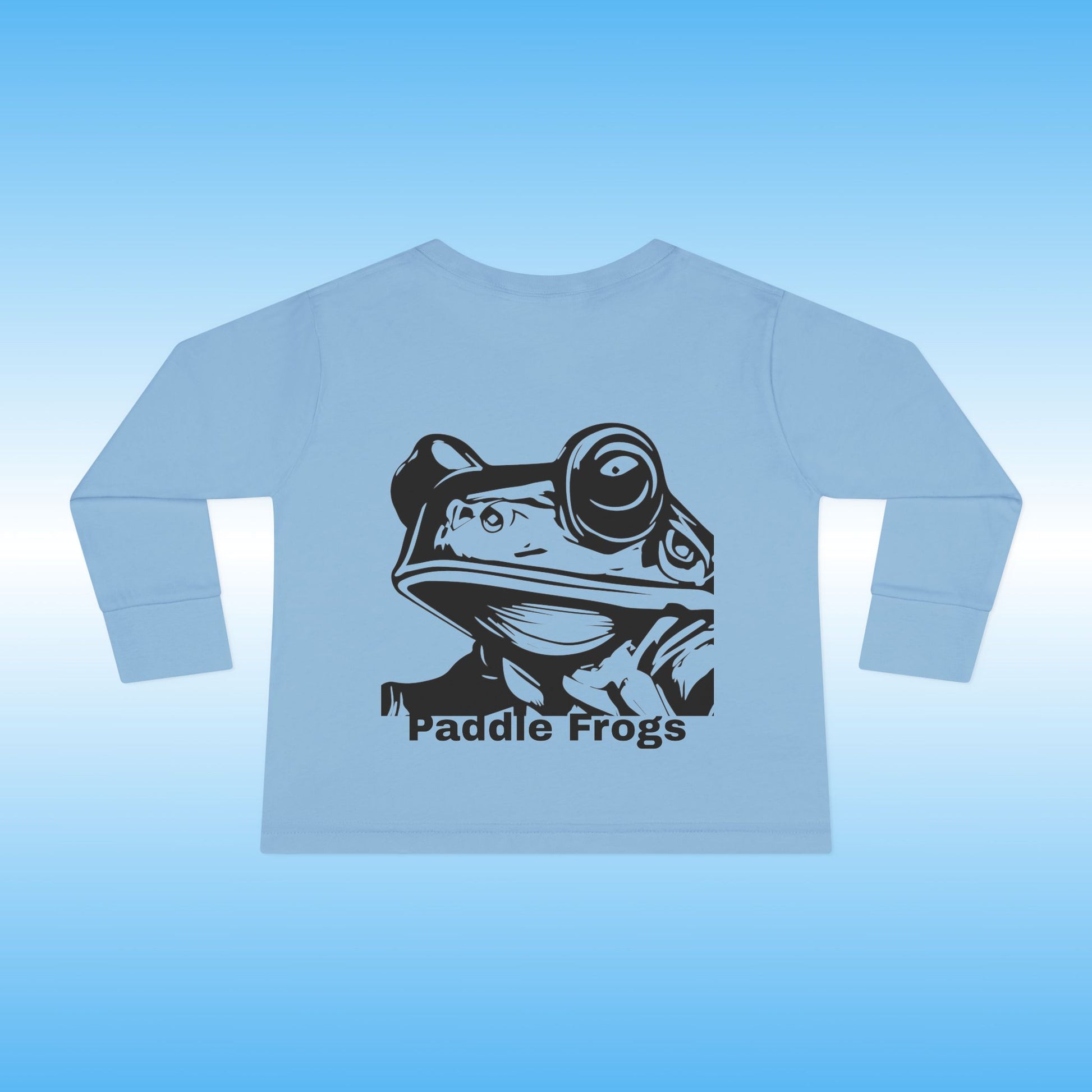 Light blue long-sleeve shirt with a black frog graphic and 'Paddle Frogs' text on a light blue background