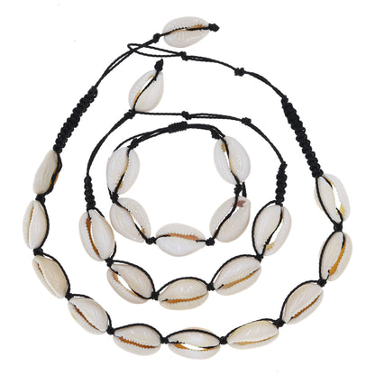 Necklace made of white shell beads on a black cord against a white background