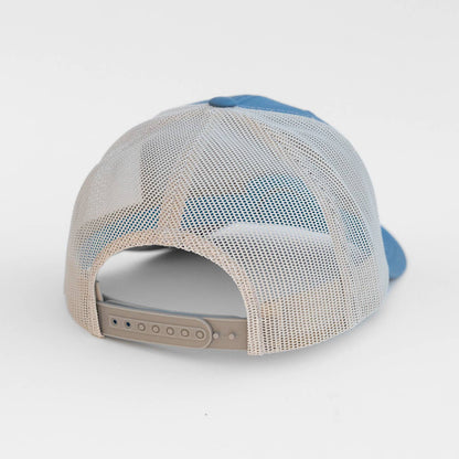 Trucker hat with blue and beige design on a white background