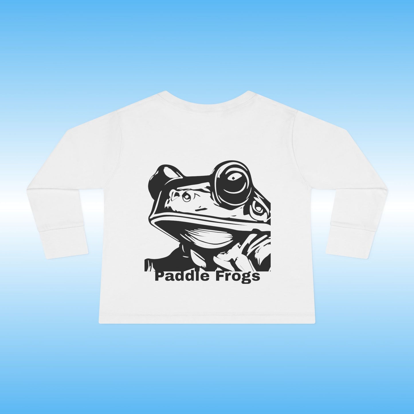 White t-shirt with black frog graphic and 'Paddle Frogs' text on a blue background