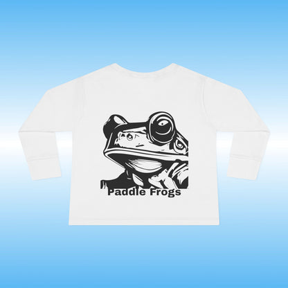 White t-shirt with black frog graphic and 'Paddle Frogs' text on a blue background