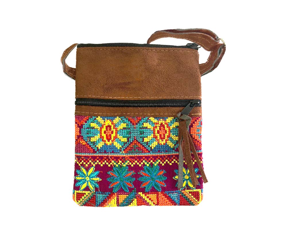 Brown leather crossbody bag with colorful embroidered pattern on a white background