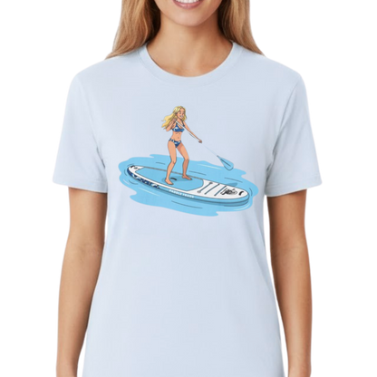 Light blue t-shirt with a graphic of a woman on a Divine Escape paddleboard by Paddle Frogs Outdoor Gear worn by a lady on a transparent background