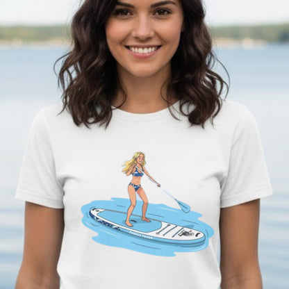 Woman wearing a white t-shirt with a graphic of a woman on a paddleboard. Aqua Babe Tee -Divine Escape paddleboard shirt White color modeled by the crew at Harrison Bay State Park in Tennessee