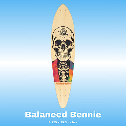 Skateboard deck with skull design on a blue background, featuring the Paddle Frogs brand character 'Balanced Bennie'.