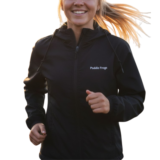 Person wearing a black jacket with 'Paddle Frogs' logo, running outdoors. Black Windbreaker Hooded Jacket Paddle Frogs™ Transparent background