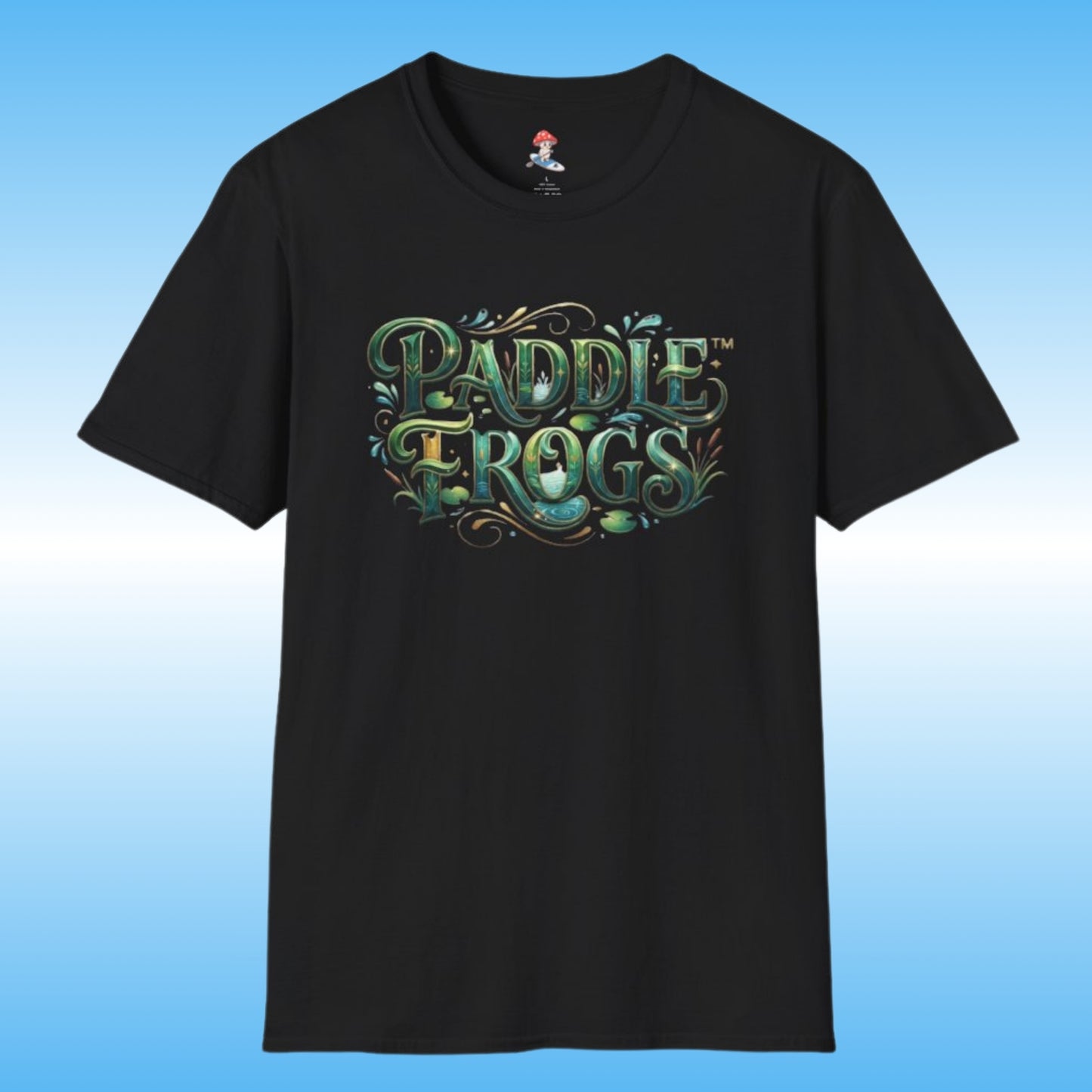 A black short-sleeve paddleboarding t-shirt featuring a stylized 'Paddle Frogs' graphic on the chest in green, teal, and gold tones, set against a light blue gradient background.