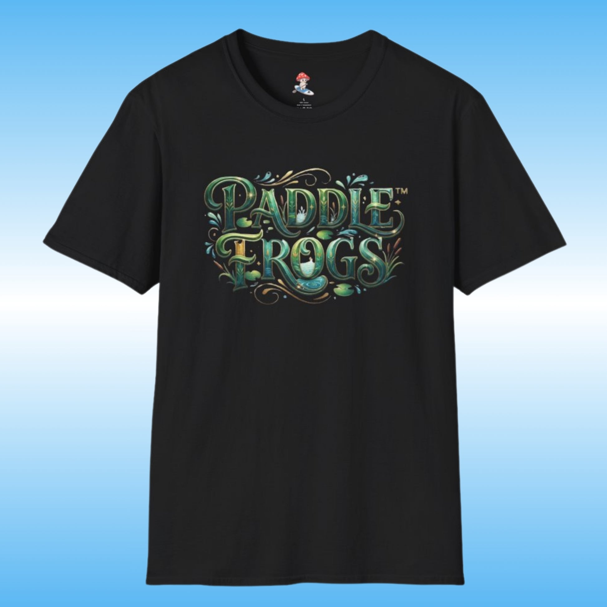 A black short-sleeve paddleboarding t-shirt featuring a stylized 'Paddle Frogs' graphic on the chest in green, teal, and gold tones, set against a light blue gradient background.